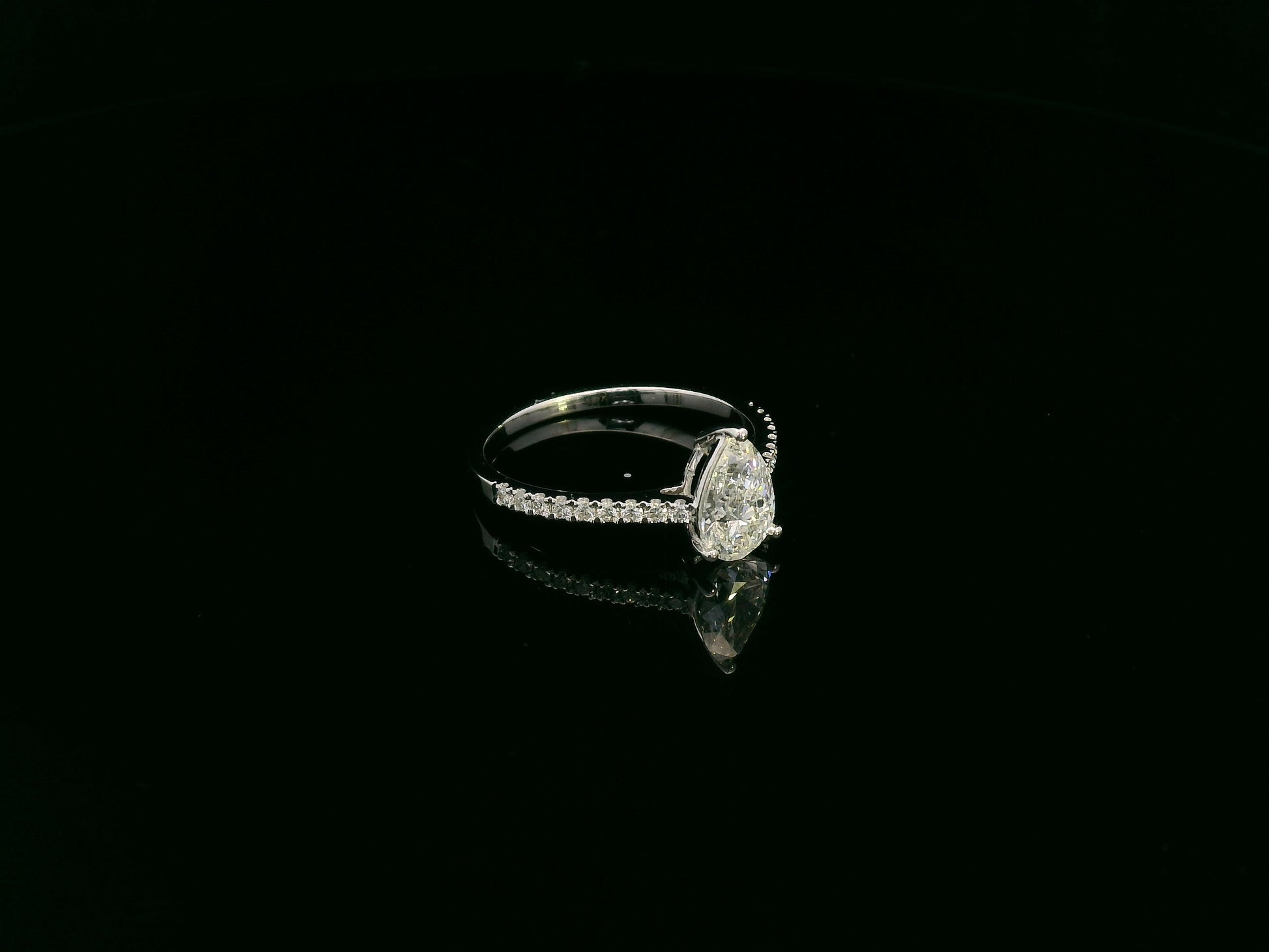 1.01 carat GIA certified pear diamond engagement ring in 18K white gold with pavé band by Emirates Diamonds Dubai