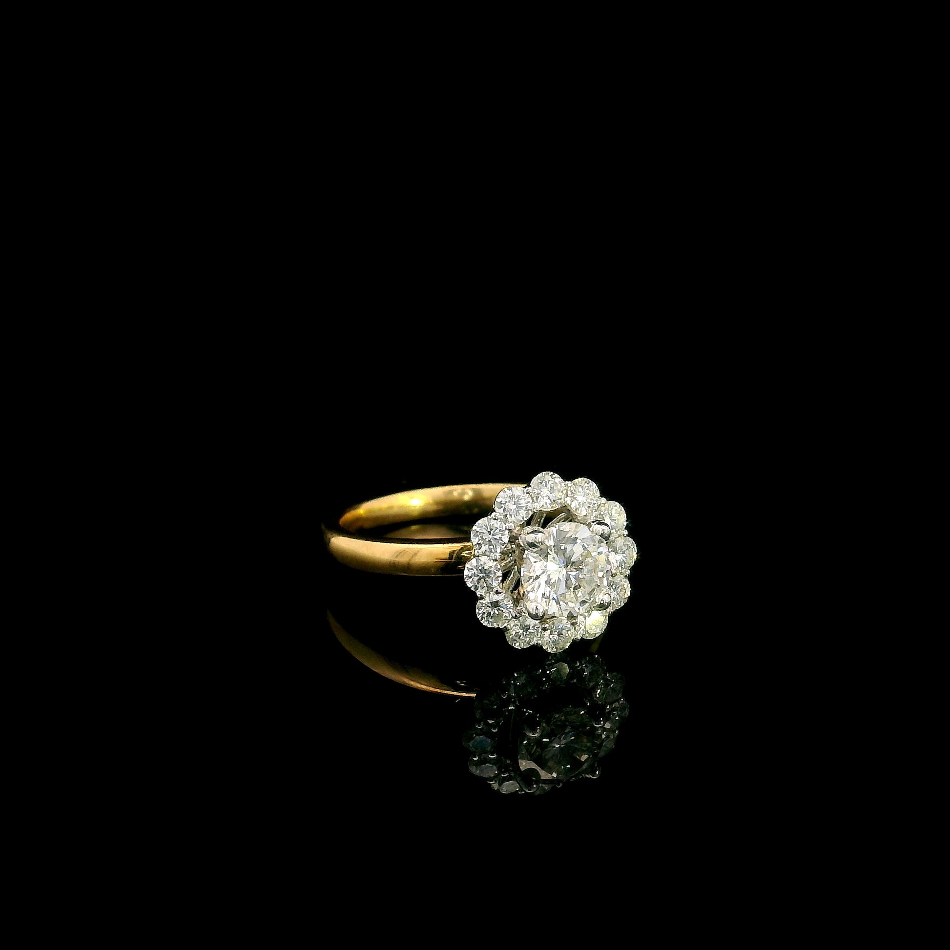 Natural diamond halo engagement ring in solid 18K yellow gold featuring a 0.70 carat IGI certified round brilliant centre diamond surrounded by 0.51 carat natural diamonds.