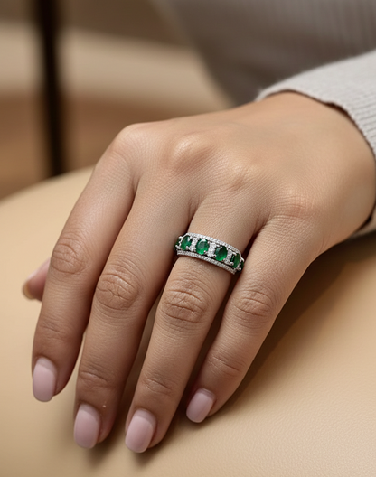 Emerald and diamond five-stone ring in 18K white gold with accents by Emirates Diamonds.