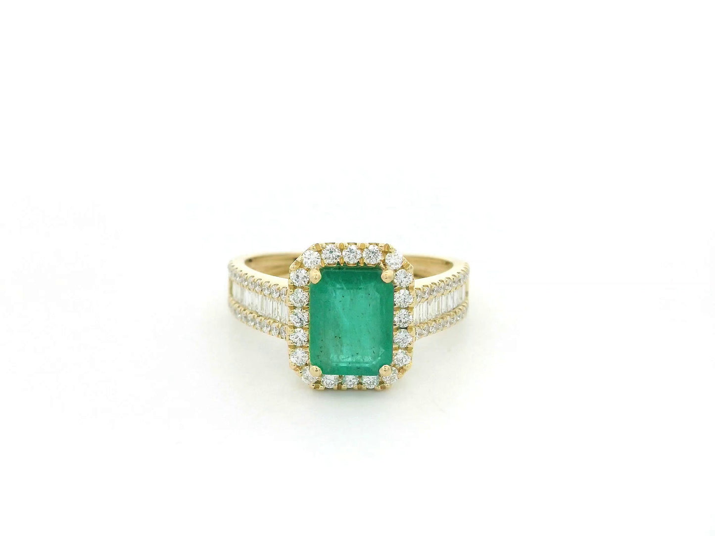 18K yellow gold emerald and diamond halo ring with baguette diamond accents by Emirates Diamonds.