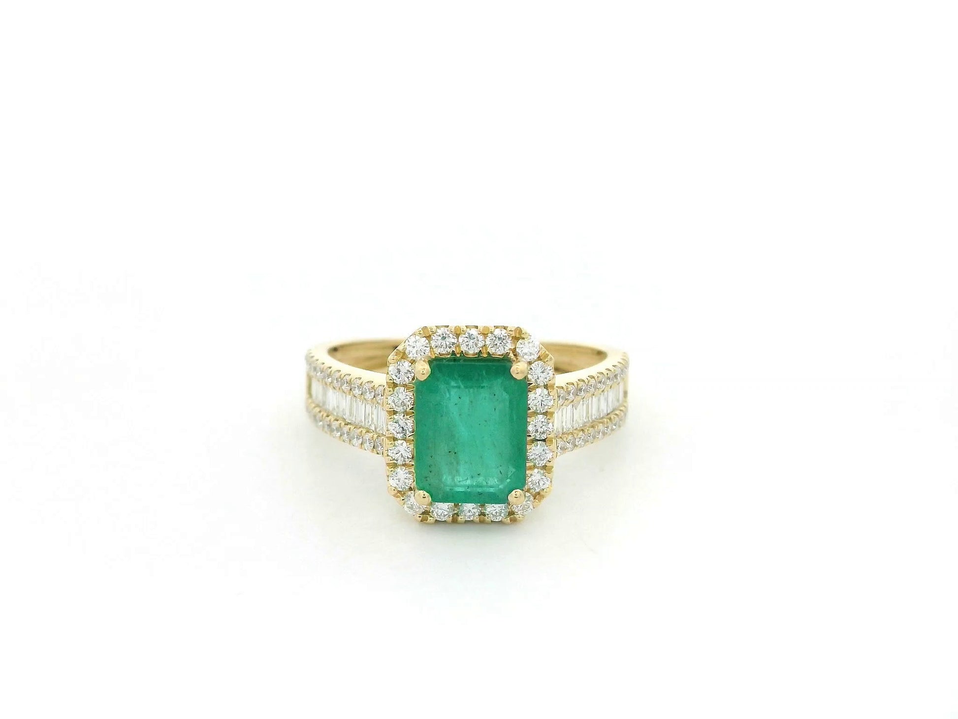 18K yellow gold emerald and diamond halo ring with baguette diamond accents by Emirates Diamonds.