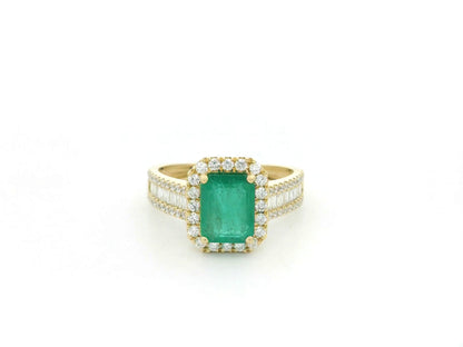18K yellow gold emerald and diamond halo ring with baguette diamond accents by Emirates Diamonds.