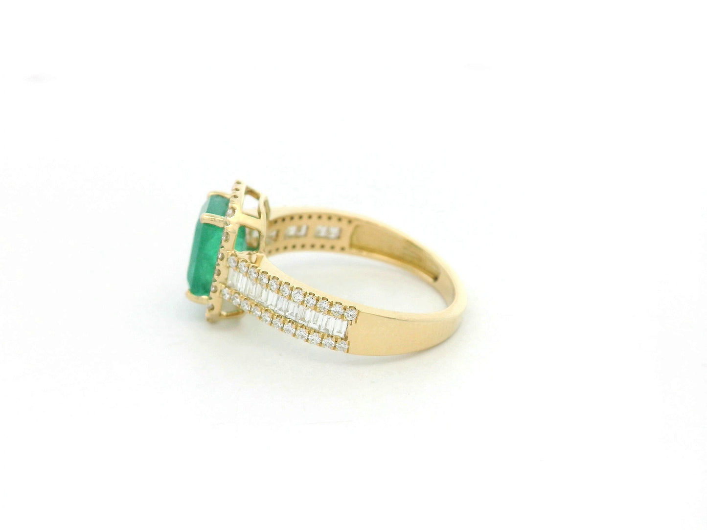 18K yellow gold emerald and diamond halo ring with baguette diamond accents by Emirates Diamonds.