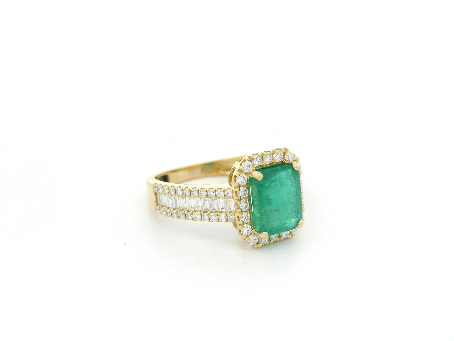 18K yellow gold emerald and diamond halo ring with baguette diamond accents by Emirates Diamonds.