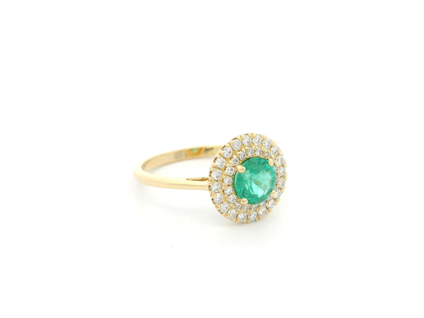 18K yellow gold emerald and diamond halo ring with round emerald center, luxury fine jewelry by Emirates Diamonds.