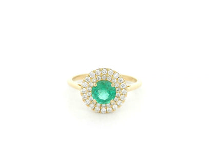 18K yellow gold emerald and diamond halo ring with round emerald center, luxury fine jewelry by Emirates Diamonds.