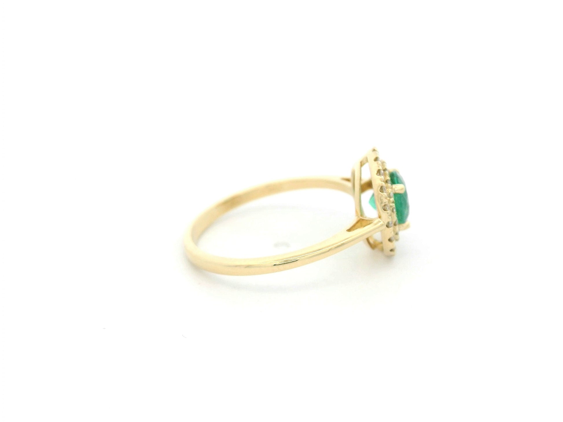 18K yellow gold emerald and diamond halo ring with round emerald center, luxury fine jewelry by Emirates Diamonds.