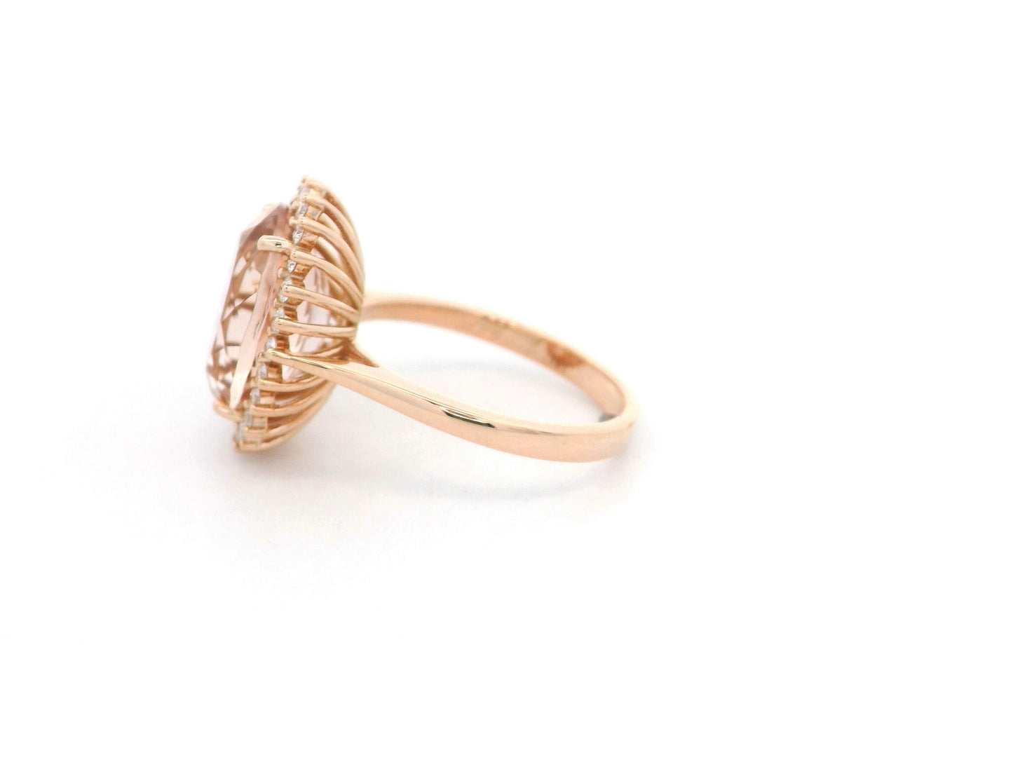 18K rose gold morganite and diamond halo ring featuring an oval morganite and sparkling diamond accents by Emirates Diamonds.