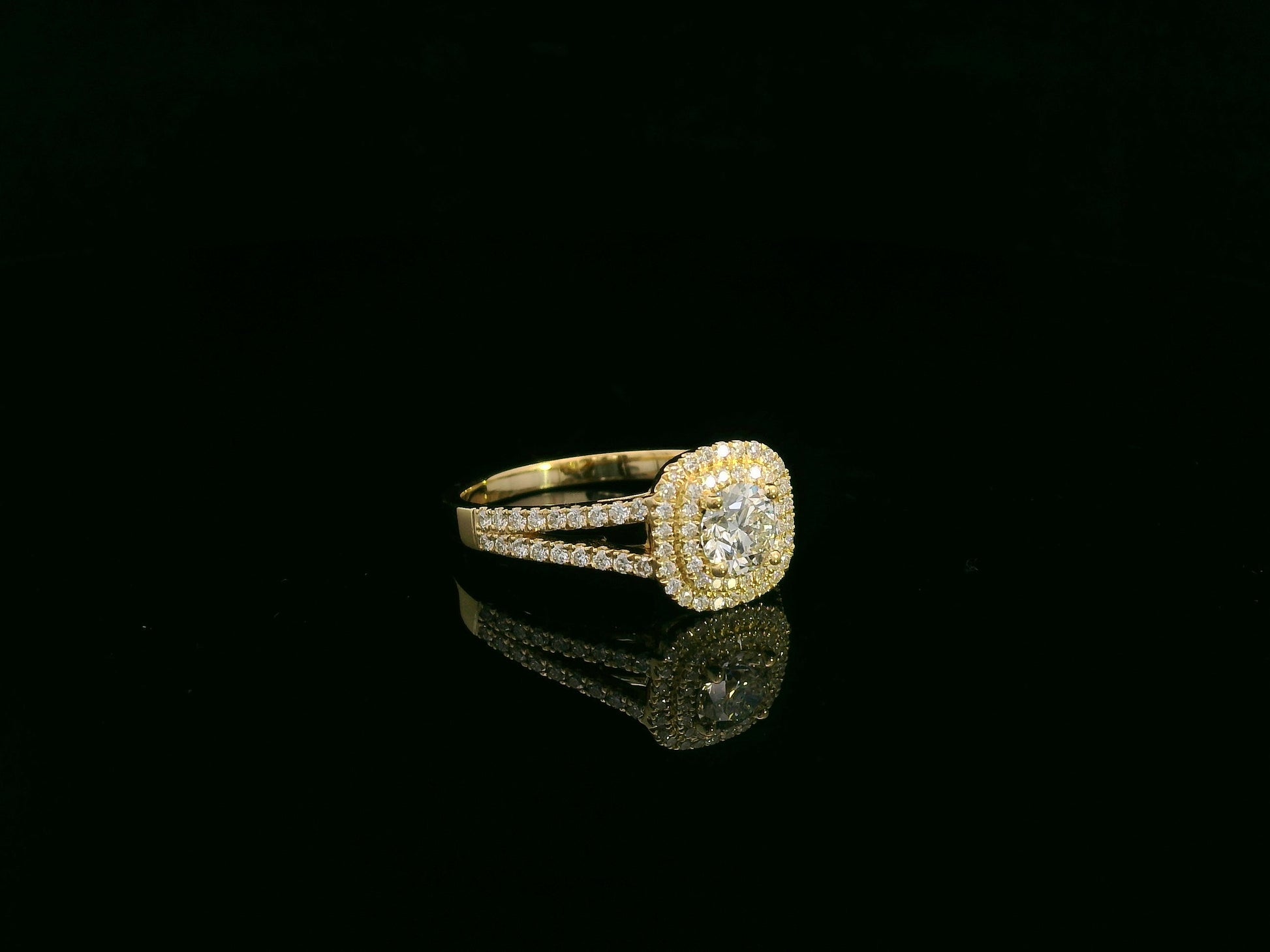 0.56 carat IGI certified diamond halo engagement ring in 18K yellow gold with split shank by Emirates Diamonds