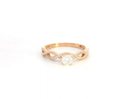 0.32 carat diamond solitaire twist engagement ring in 18K rose gold with pavé band by Emirates Diamonds