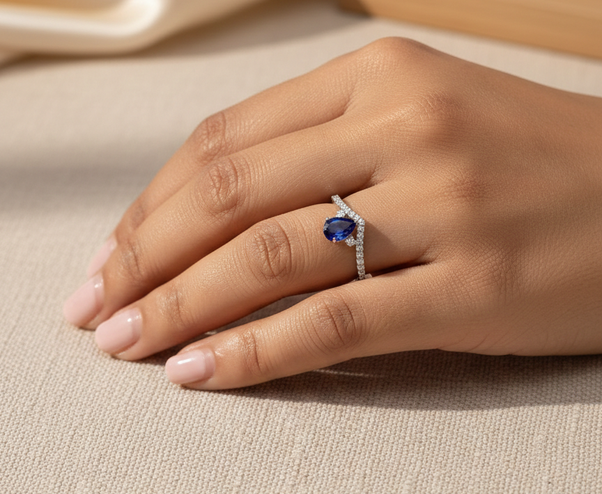 Pear blue sapphire diamond V shape ring in 18K white gold wishbone design Emirates Diamonds