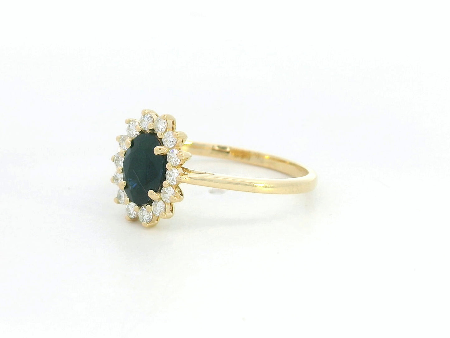 18K yellow gold oval sapphire ring with diamond halo, classic sapphire and diamond ring by Emirates Diamonds