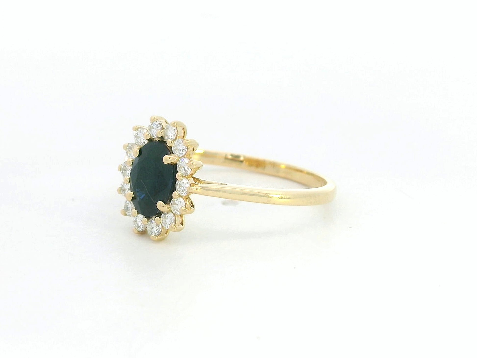 18K yellow gold oval sapphire ring with diamond halo, classic sapphire and diamond ring by Emirates Diamonds