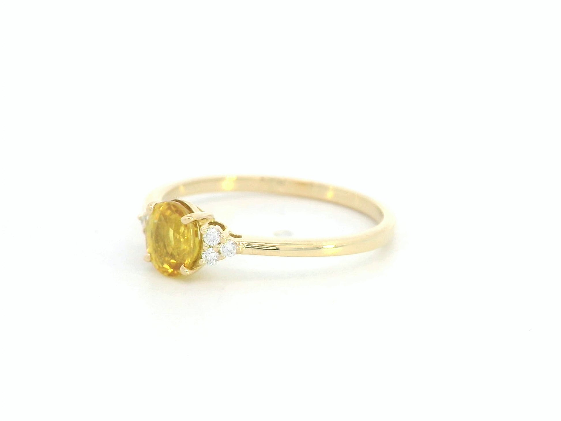 18K yellow gold ring with oval yellow sapphire and diamond accents, elegant gemstone ring by Emirates Diamonds