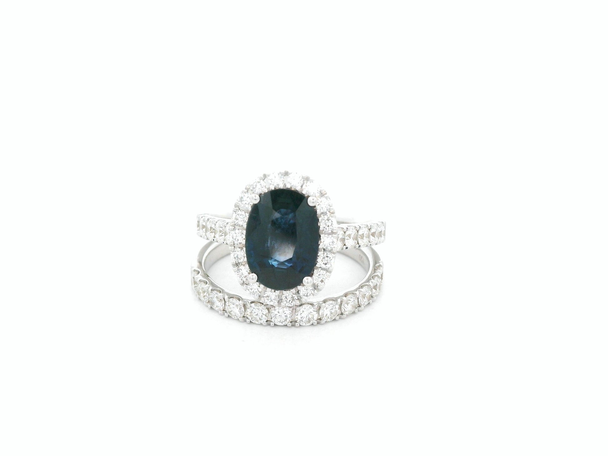 18K white gold blue sapphire and diamond bridal ring set with halo engagement ring and diamond wedding band by Emirates Diamonds