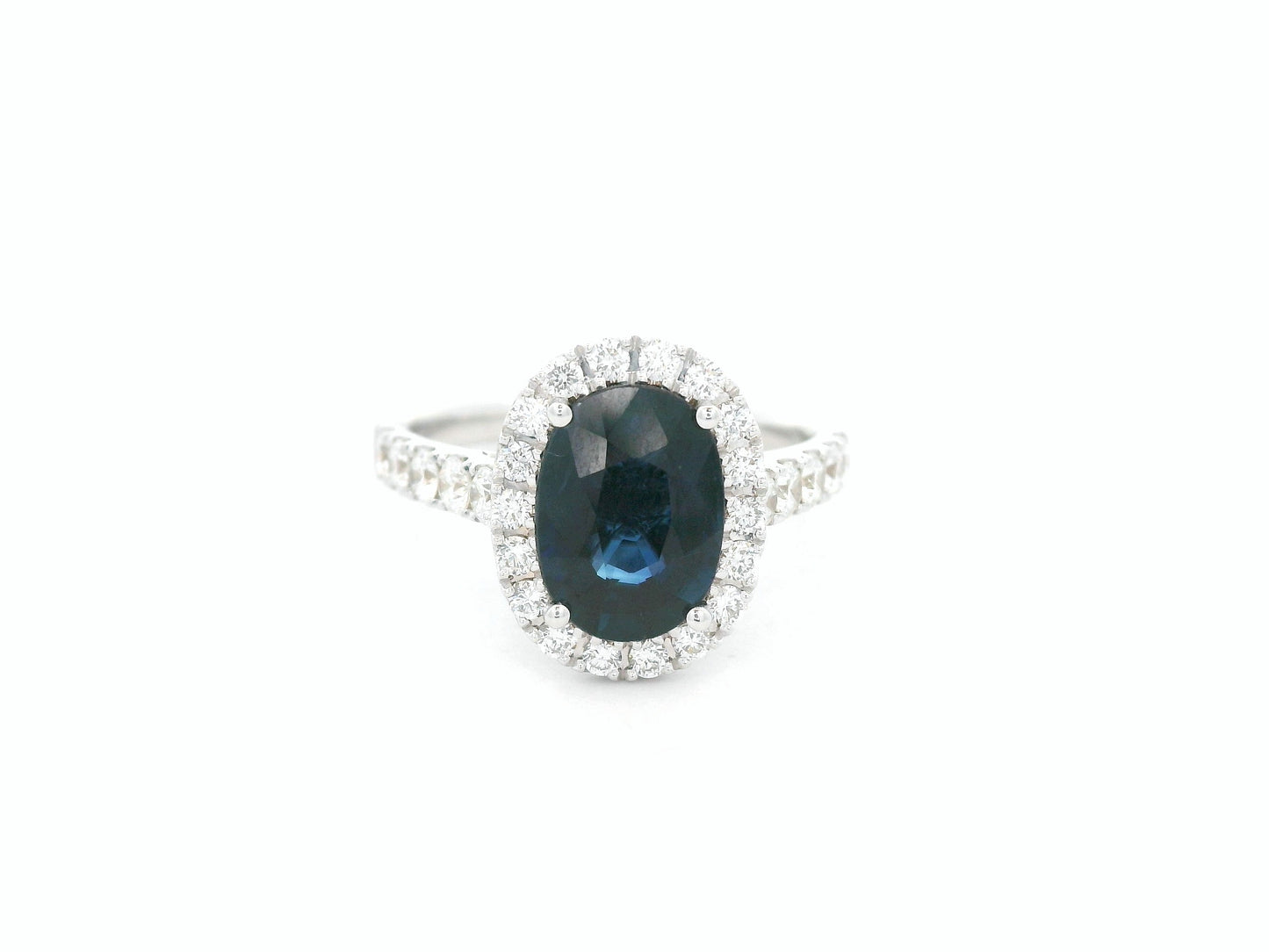 18K white gold blue sapphire and diamond bridal ring set with halo engagement ring and diamond wedding band by Emirates Diamonds