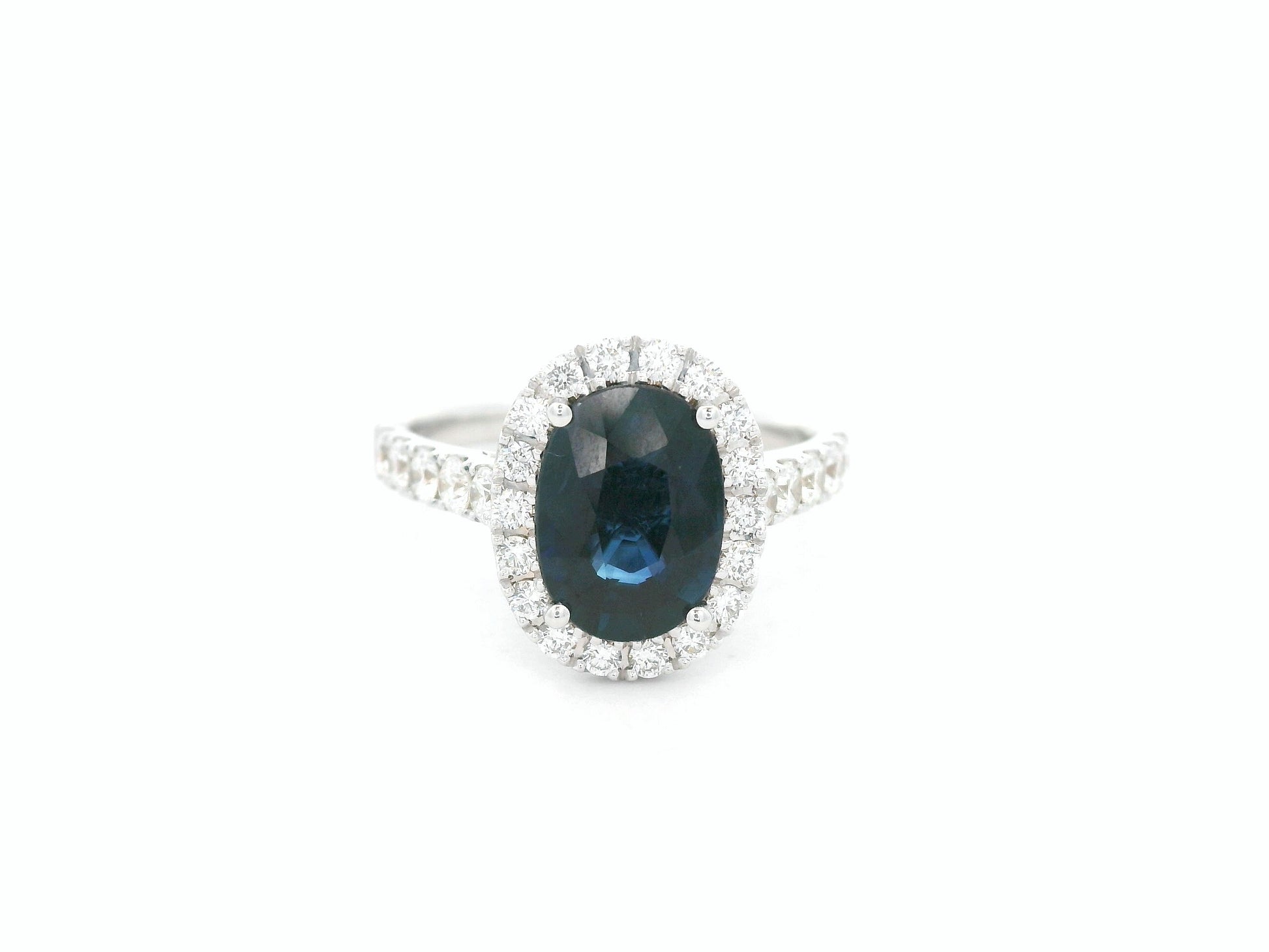 18K white gold blue sapphire and diamond bridal ring set with halo engagement ring and diamond wedding band by Emirates Diamonds