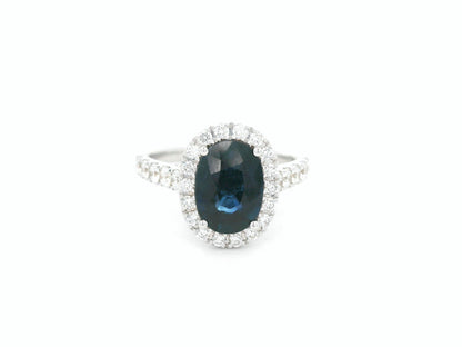 18K white gold blue sapphire and diamond bridal ring set with halo engagement ring and diamond wedding band by Emirates Diamonds
