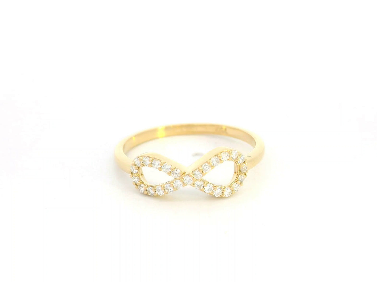 18K yellow gold infinity ring with pavé-set diamonds, total diamond weight 0.21 carat, Emirates Diamonds.
