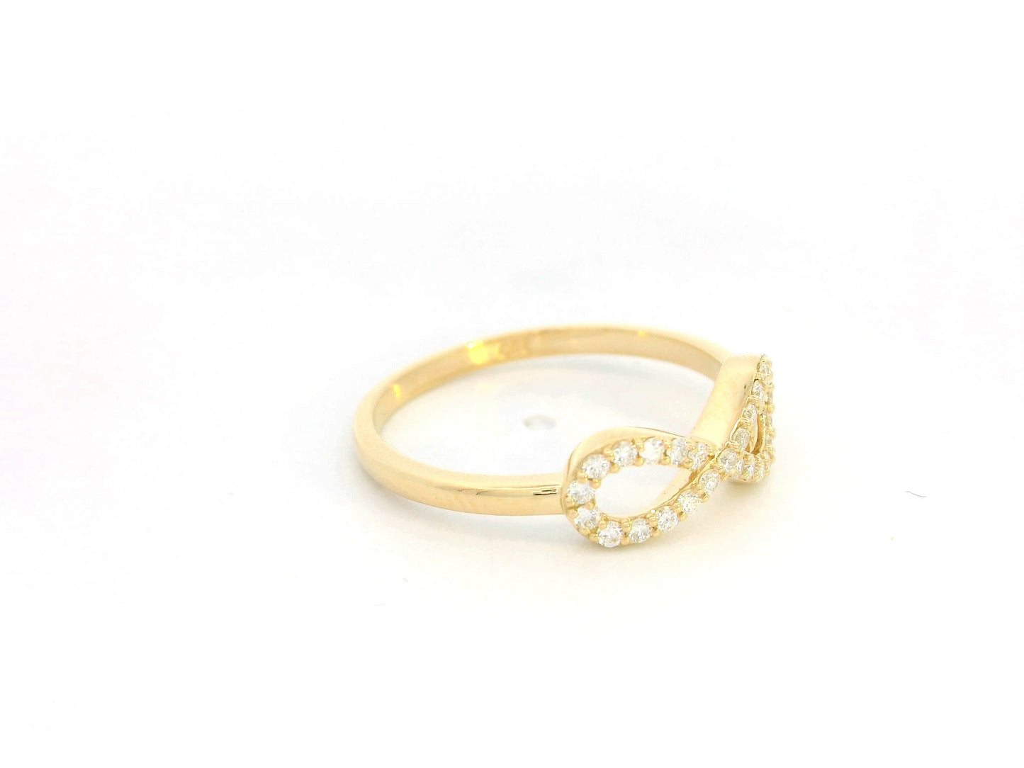 18K yellow gold infinity ring with pavé-set diamonds, total diamond weight 0.21 carat, Emirates Diamonds.