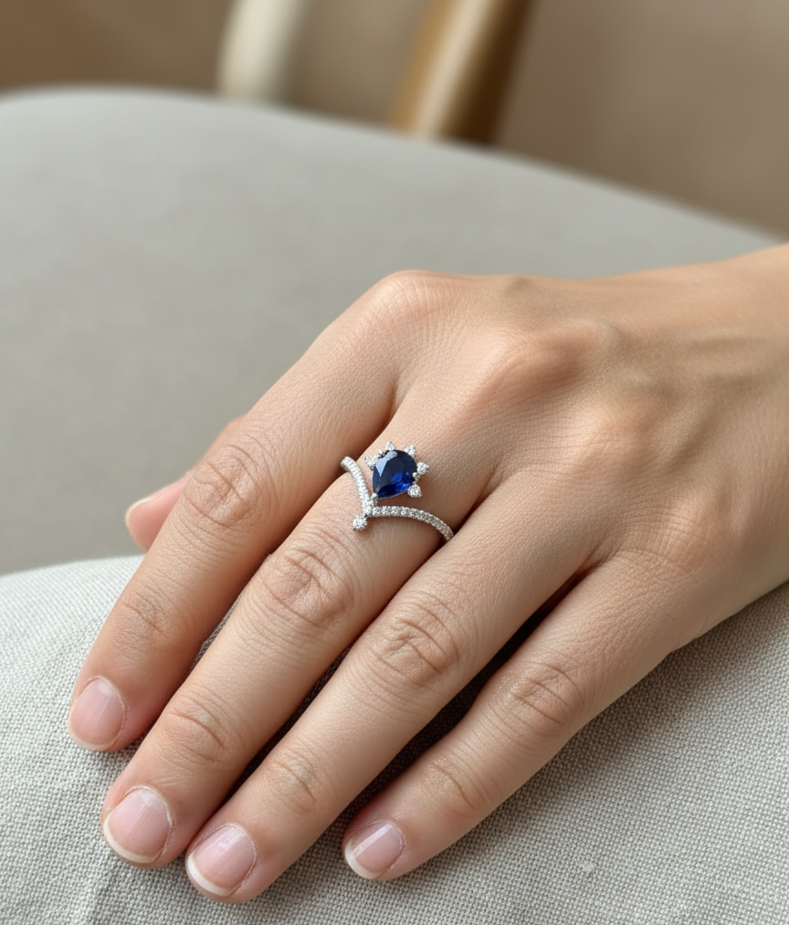 Blue sapphire pear shape diamond crown ring in 18K white gold by Emirates Diamonds