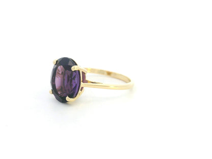 Oval amethyst solitaire ring in 18K yellow gold featuring a 4.39 carat natural amethyst by Emirates Diamonds.