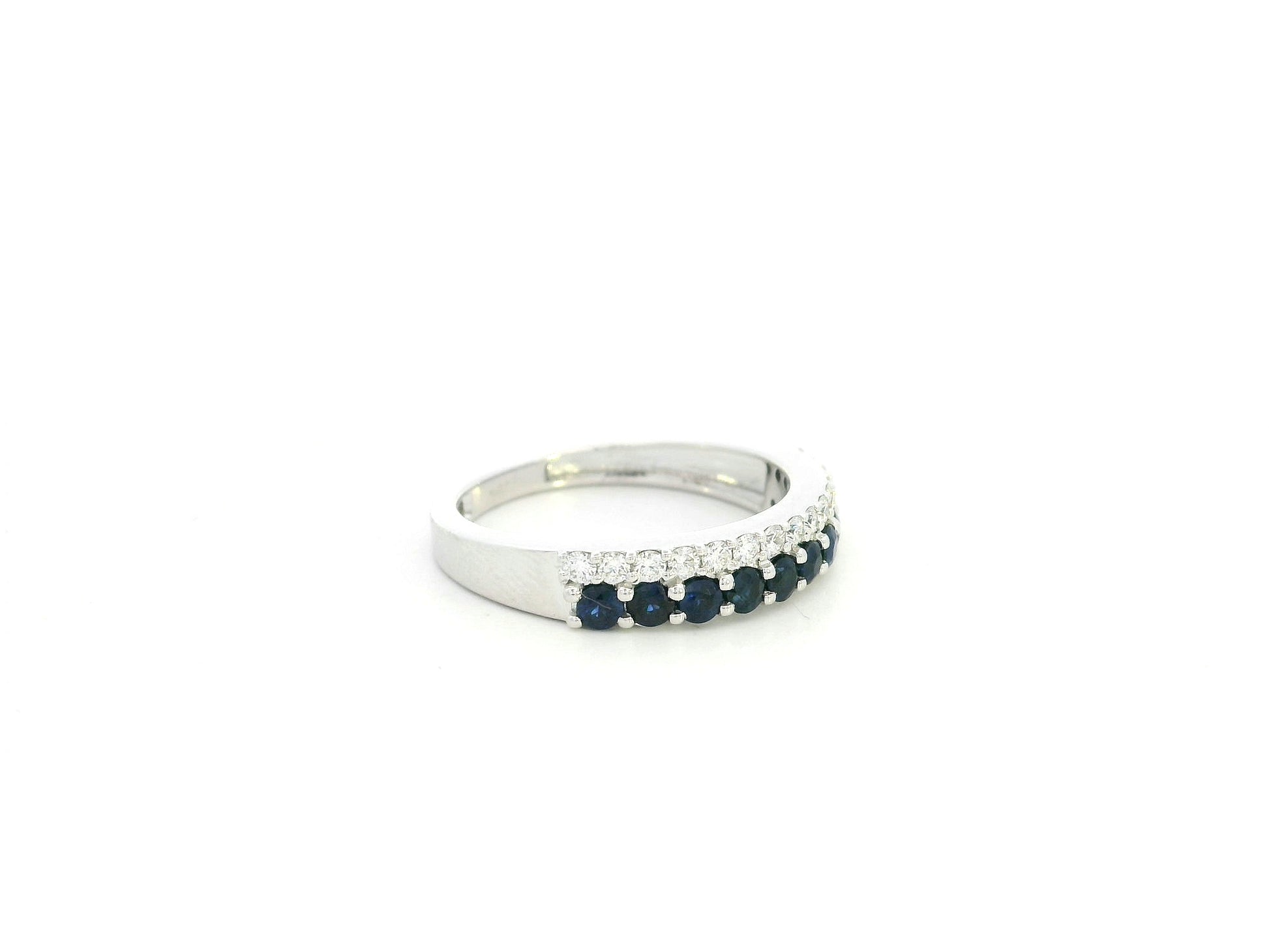 Blue sapphire and diamond band ring in 18K white gold featuring 0.62 carats of sapphires and 0.25 carats of diamonds by Emirates Diamonds.