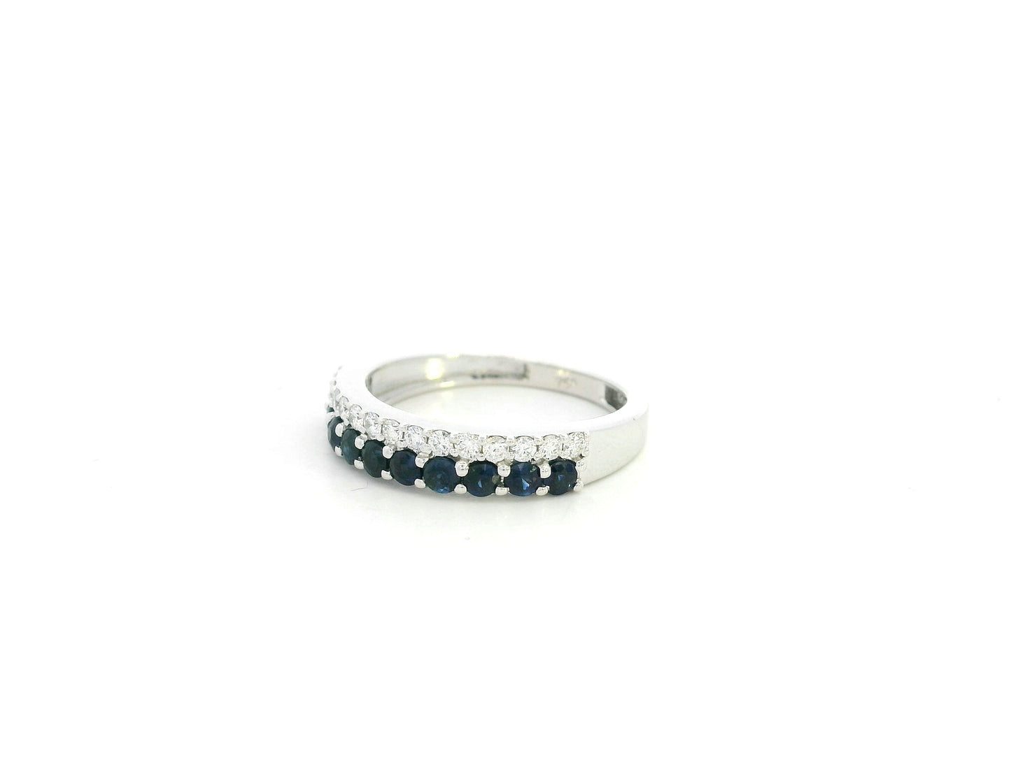 Blue sapphire and diamond band ring in 18K white gold featuring 0.62 carats of sapphires and 0.25 carats of diamonds by Emirates Diamonds.