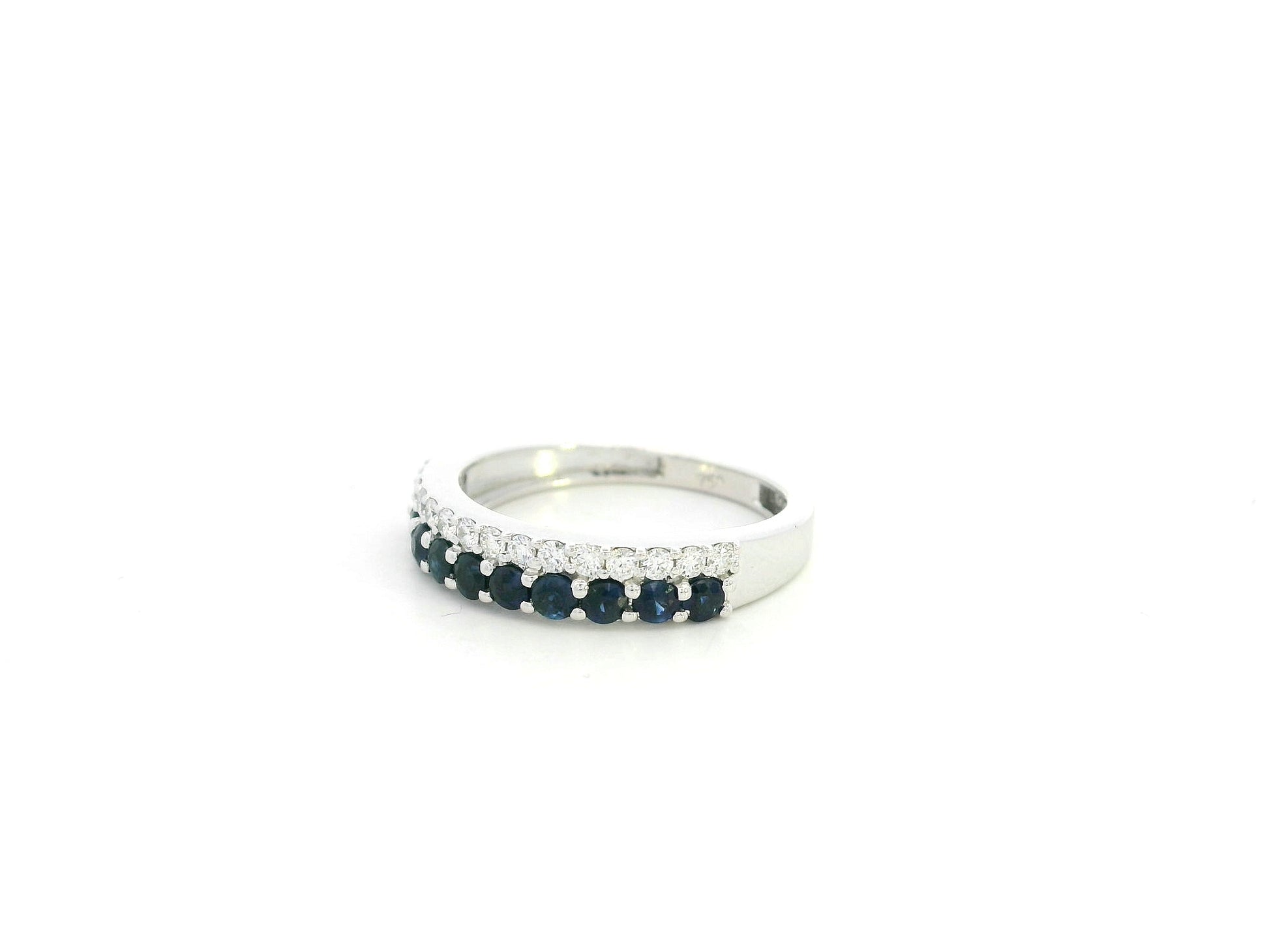 Blue sapphire and diamond band ring in 18K white gold featuring 0.62 carats of sapphires and 0.25 carats of diamonds by Emirates Diamonds.