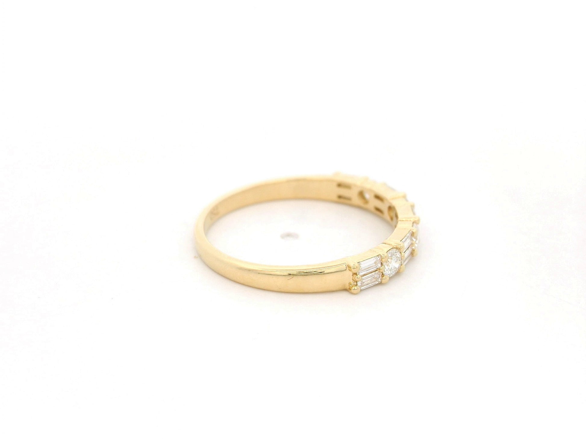 Round and baguette diamond band ring in 18K yellow gold by Emirates Diamonds