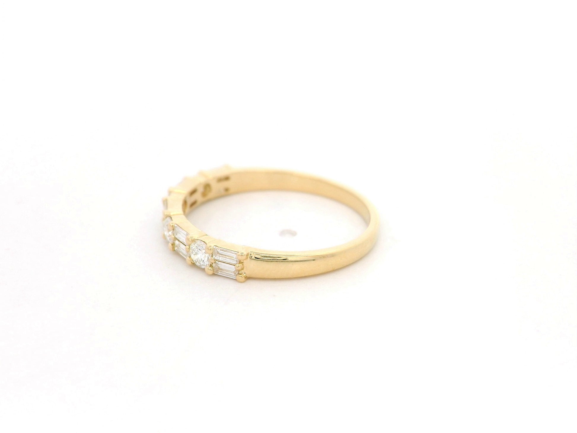 Round and baguette diamond band ring in 18K yellow gold by Emirates Diamonds