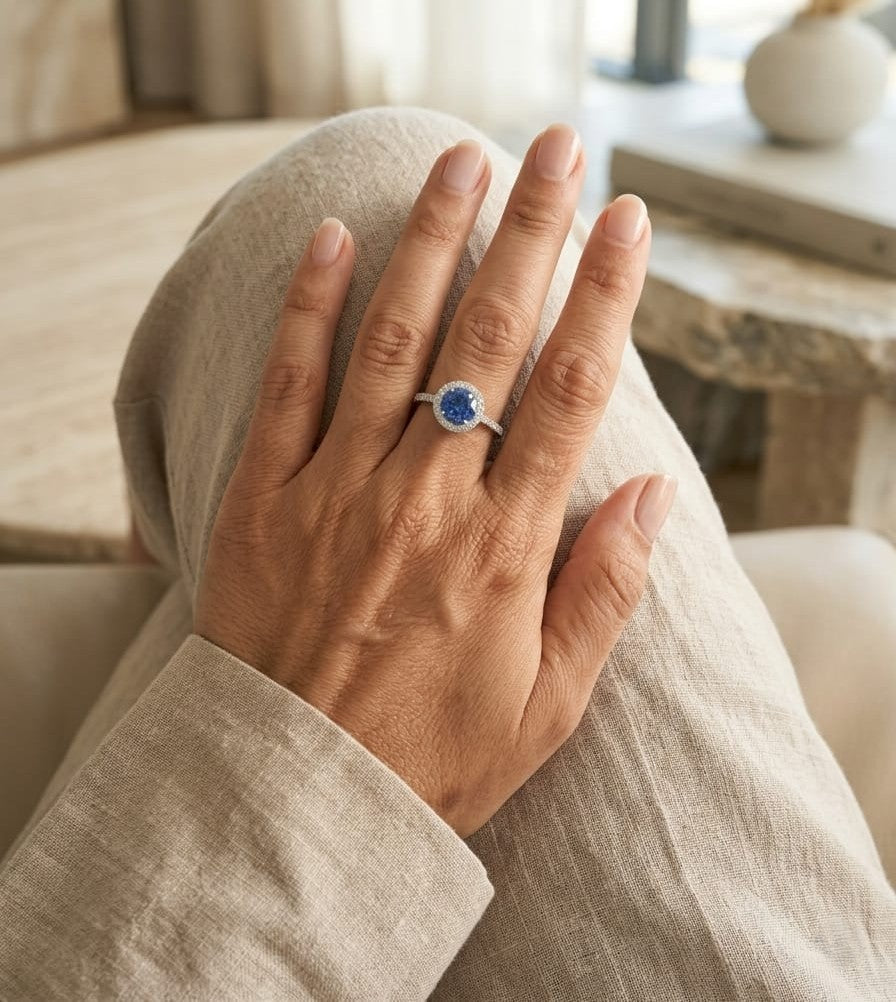 Blue sapphire halo ring with diamonds in 18K white gold by Emirates Diamonds