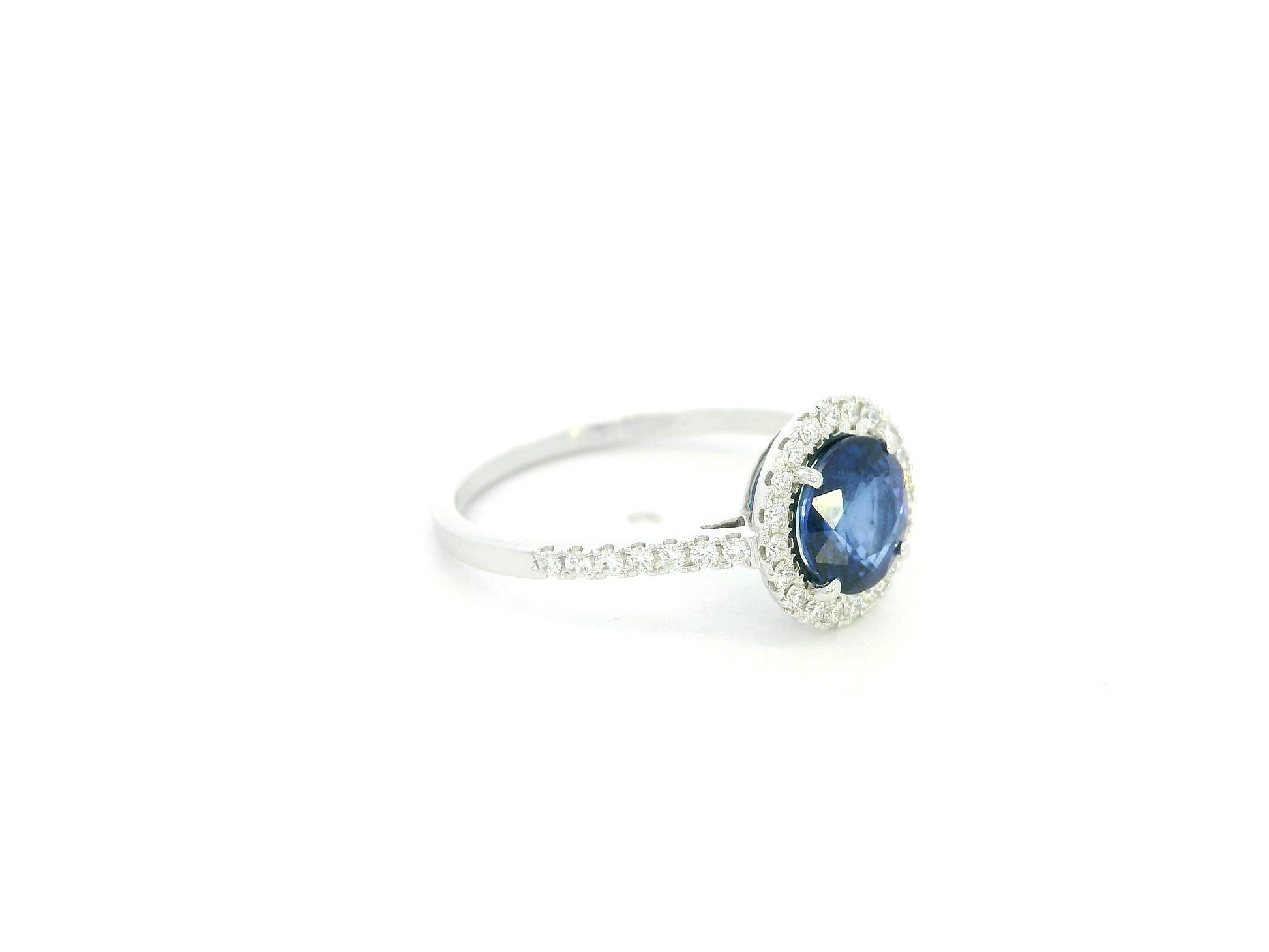 Blue sapphire halo ring with diamonds in 18K white gold by Emirates Diamonds