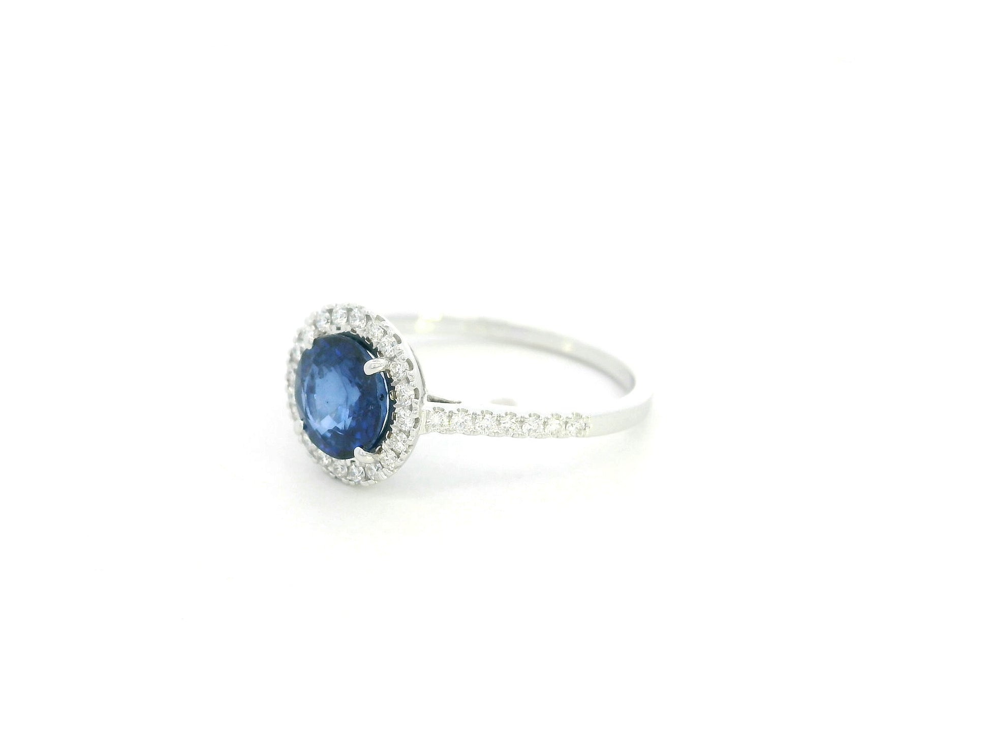 Blue sapphire halo ring with diamonds in 18K white gold by Emirates Diamonds
