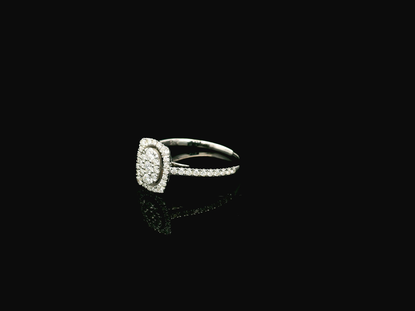 Diamond cluster halo ring in 18K white gold with oval diamond cluster and pavé band