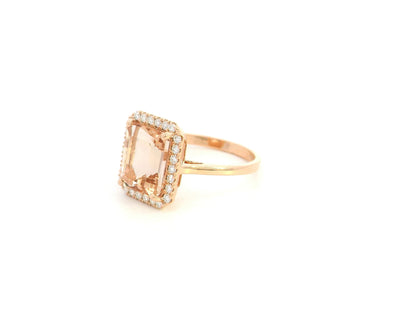 Emerald cut morganite halo ring with diamonds in 18K rose gold by Emirates Diamonds