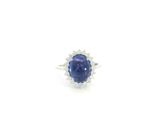 Cabochon tanzanite diamond halo ring in 18K white gold with oval blue tanzanite