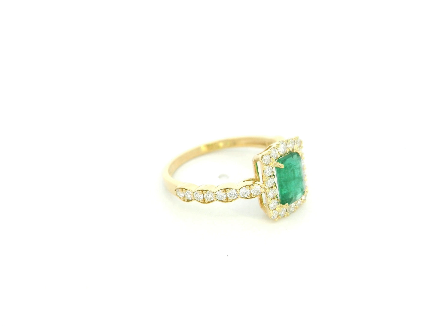 Emerald diamond halo ring in 18K yellow gold with emerald cut center and diamond band