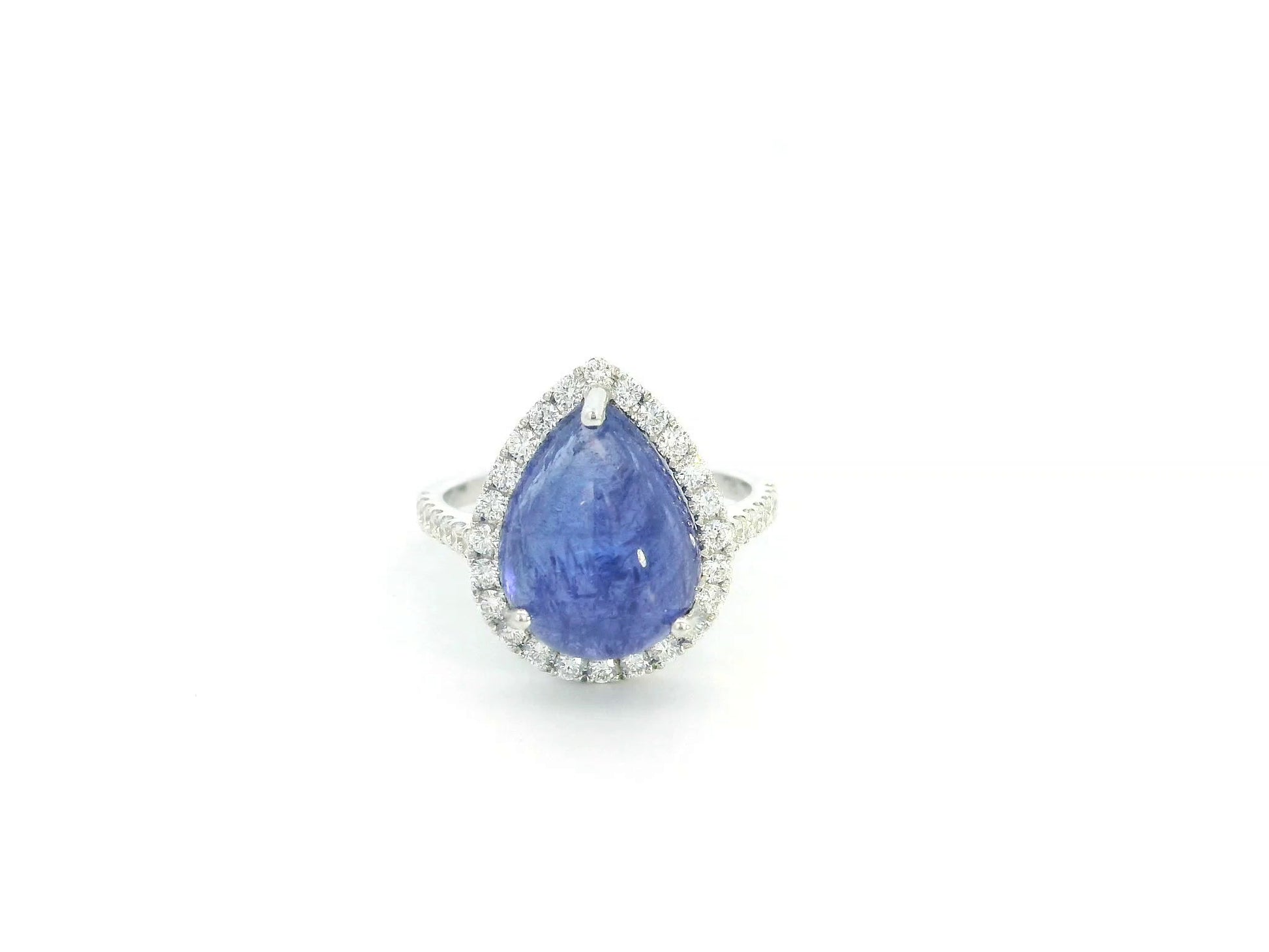 Cabochon tanzanite diamond halo ring in 18K white gold with pear-shaped blue gemstone