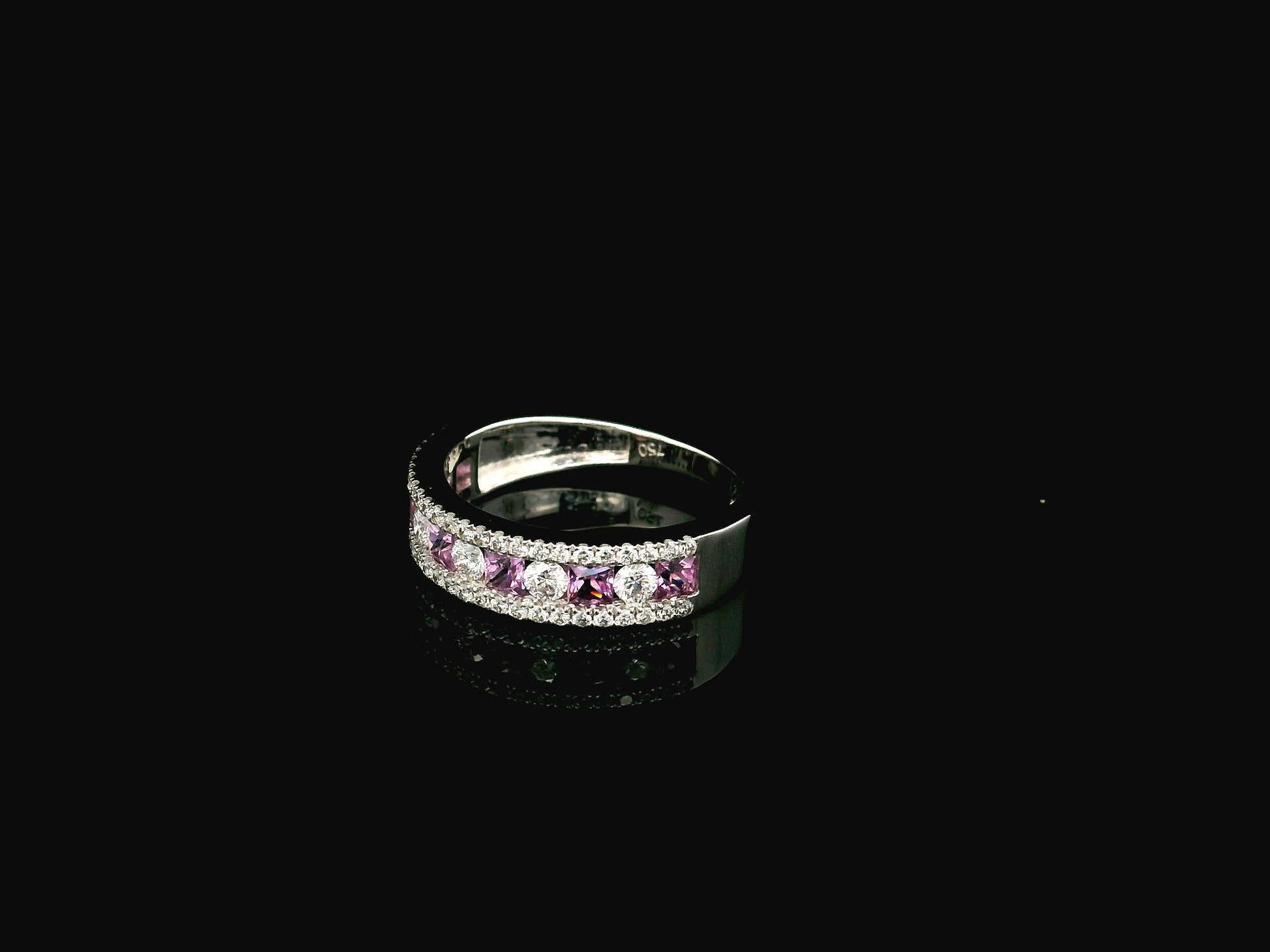 Pink sapphire diamond eternity band ring in 18K white gold with alternating princess cut sapphires