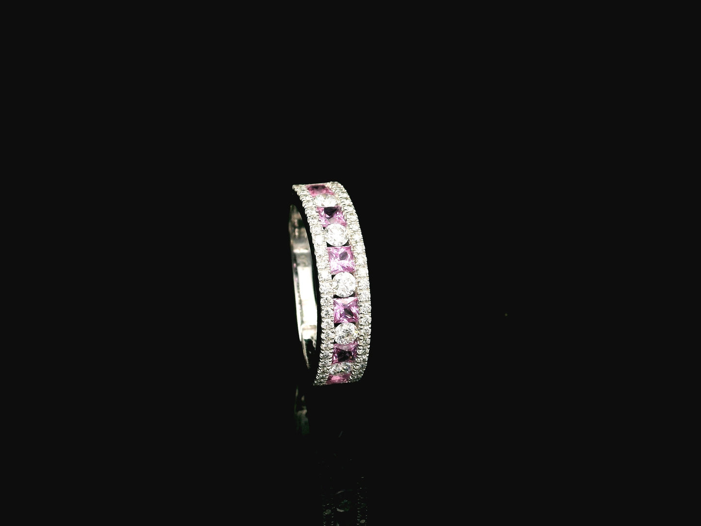 Pink sapphire diamond eternity band ring in 18K white gold with alternating princess cut sapphires