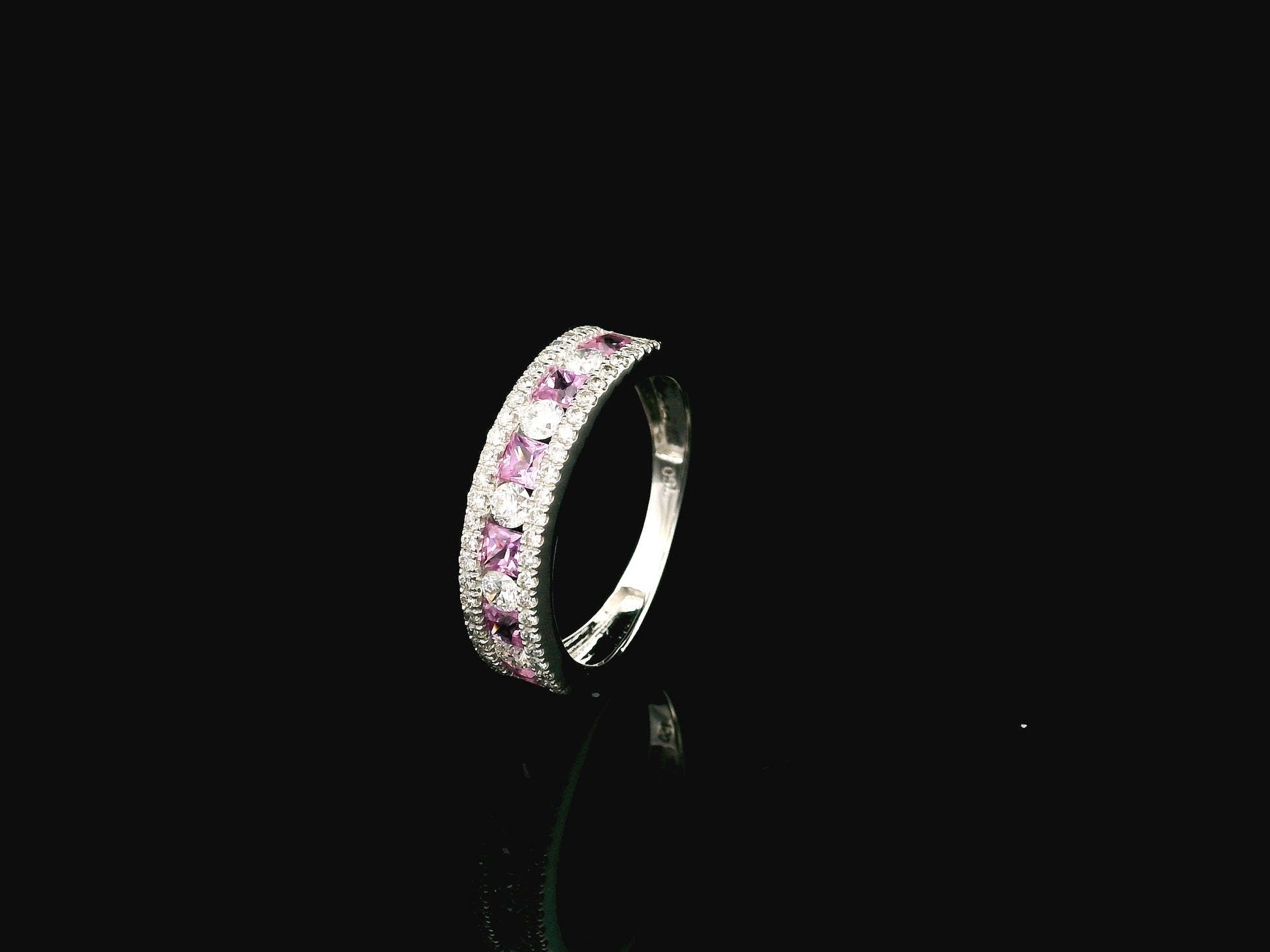 Pink sapphire diamond eternity band ring in 18K white gold with alternating princess cut sapphires
