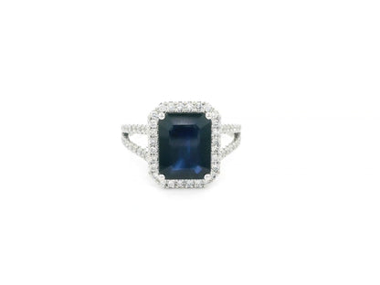 Emerald cut blue sapphire halo ring in 18K white gold with diamond split band Emirates Diamonds
