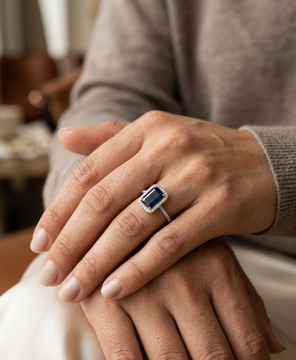 Emerald cut blue sapphire halo ring in 18K white gold with diamond accents Emirates Diamonds