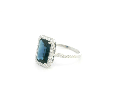 Emerald cut blue sapphire halo ring in 18K white gold with diamond accents Emirates Diamonds