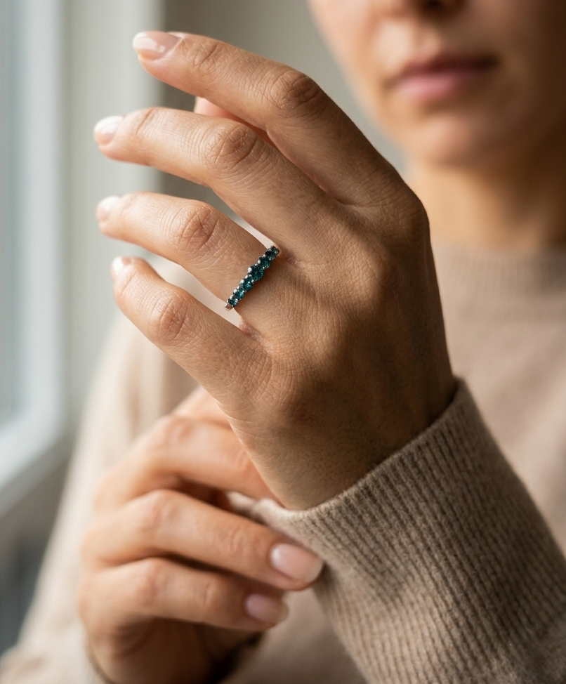 Shop a 0.50 carat blue diamond half eternity ring in 18K white gold. A bold, stackable luxury band by Emirates Diamonds.