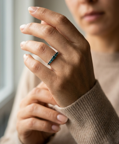 Shop a 0.50 carat blue diamond half eternity ring in 18K white gold. A bold, stackable luxury band by Emirates Diamonds.