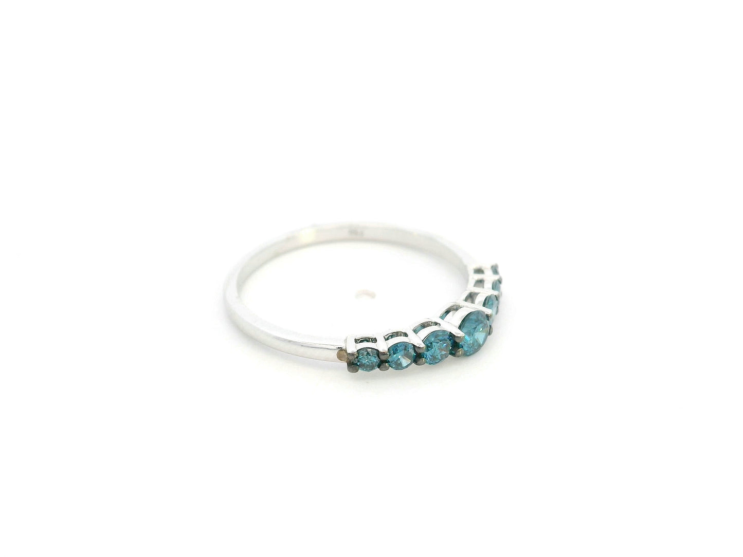 Shop a 0.50 carat blue diamond half eternity ring in 18K white gold. A bold, stackable luxury band by Emirates Diamonds.