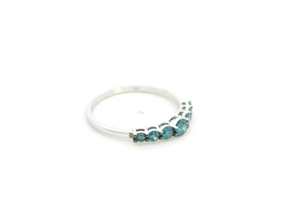 Shop a 0.50 carat blue diamond half eternity ring in 18K white gold. A bold, stackable luxury band by Emirates Diamonds.
