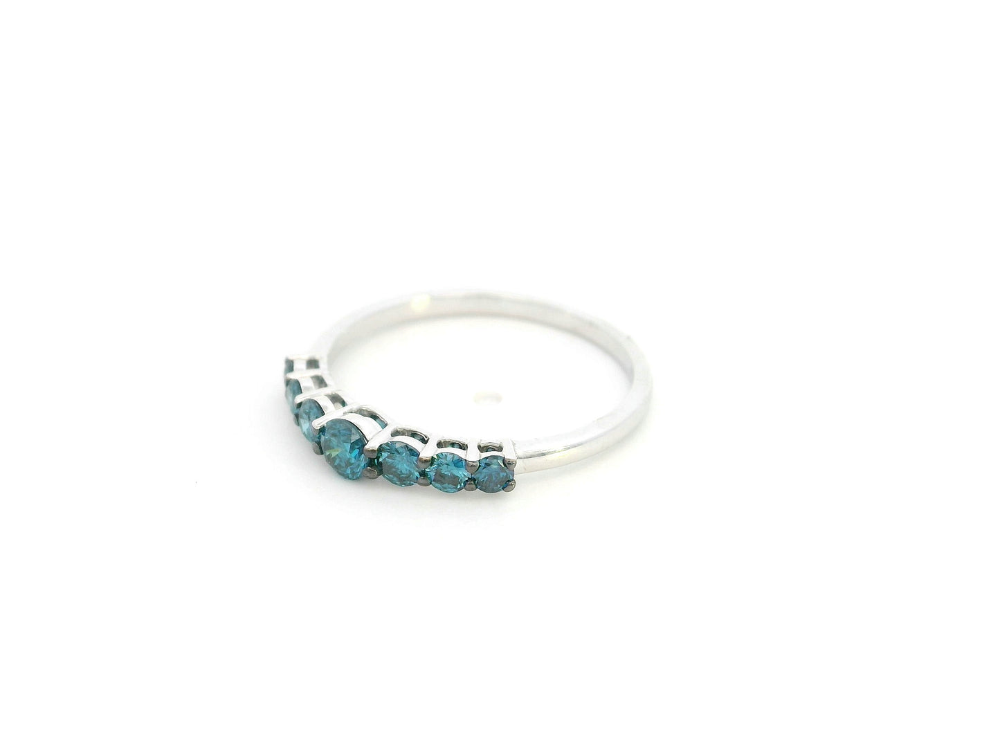 Shop a 0.50 carat blue diamond half eternity ring in 18K white gold. A bold, stackable luxury band by Emirates Diamonds.